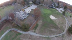 This house is actually located on the second fairway and has its share of broken windows, shutters, etc.  They also get to sell a lot of golf balls at flea markets.  This shot is from about 125' up.  It's a real bitch chipping around the trees in that yard. 